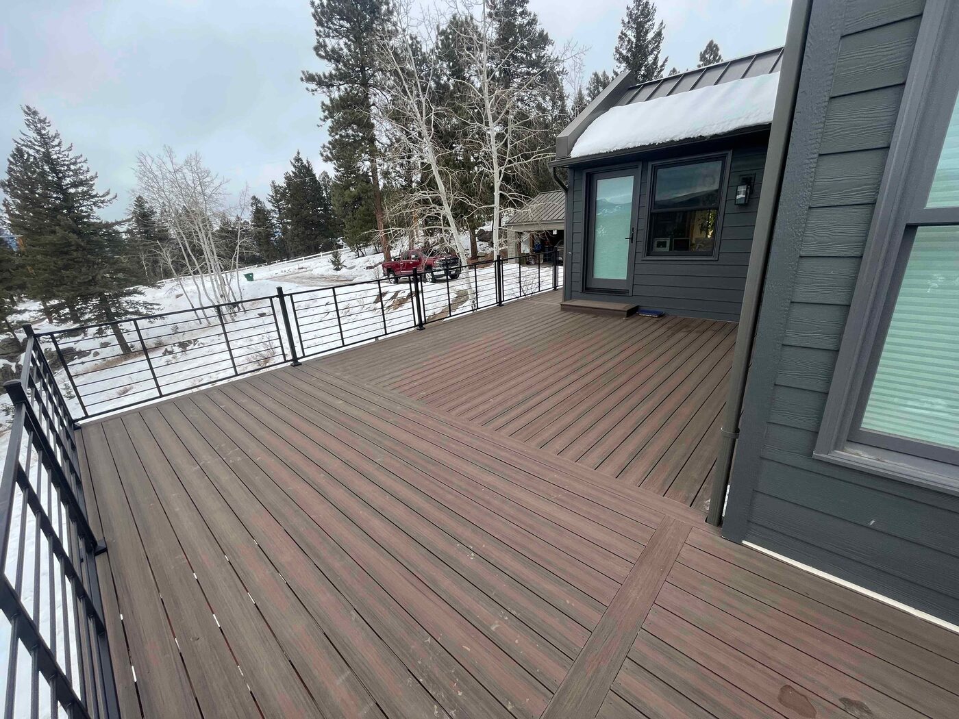 Composite deck overlooking a snowy Front Range view in Larkspur